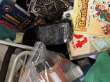 a basket full of toys and books on the floor