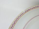 a white plate with purple and yellow designs on it