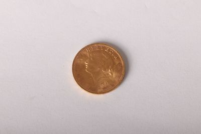 a close up of a penny sitting on a white surface