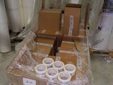 many rolls of tape sitting on a pallet in a warehouse