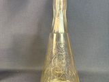 a glass vase and a glass bottle on a table