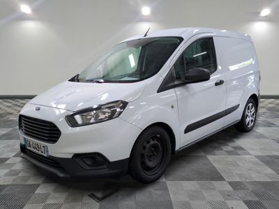 la camionnette blanche est garée sur un sol carrelé en damier