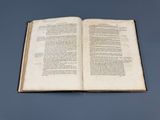 an open book on a table with a blue background