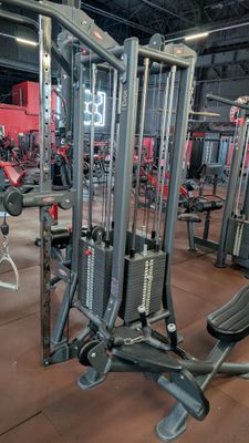 a gym with a lot of machines in the room
