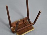 a small wooden chair with two legs on a gray surface