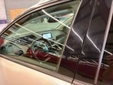 a reflection of a car in the window of a car