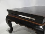 a black table with a wooden top on a white background