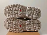 the soles of a pair of running shoes sitting on top of a box