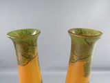 two vases that are sitting on a table