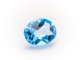 a close up of a blue topazte gems on a white background
