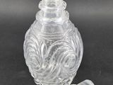 a clear glass vase with a glass stopper on it