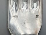 a silver fork with a hole in the middle of it