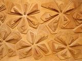 a lot of paper flowers on the wall of a building