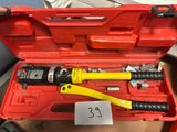someone is holding a tool in a red case with a price tag