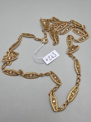 a close up of a gold chain with a tag on it