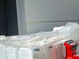 a pallet full of white containers sitting on a pallet