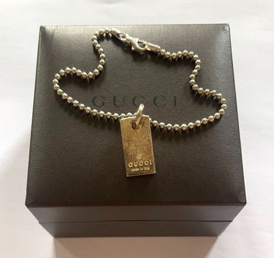a close up of a box with a chain and a tag on it