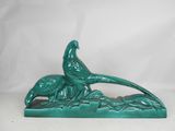 green ceramic sculpture of a pheasant and a bird on a branch