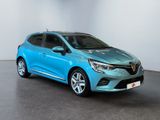 a blue car is parked in a room with a white wall