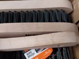 a box full of black brushes sitting on a table