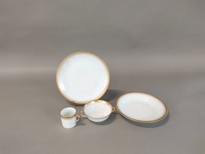 three white and gold dishes and cups sitting on a table