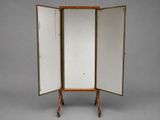 an old wooden easel with three open doors on a gray background