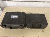 two black cases sitting on top of a table next to each other