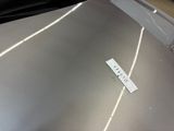 a sticker on the hood of a silver car
