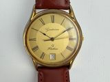 a close up of a watch with roman numerals on the face