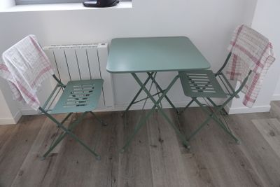 two chairs and a table in the corner of a room