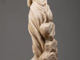an image of a statue of a woman holding a dog