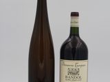 two bottles of wine sitting next to each other on a white surface