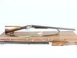 an old gun with a wooden case and a rifle on a white background