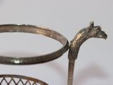 a metal basket that has a horse head on it