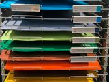 a lot of folders that are stacked up on a rack