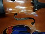 a close up of a violin that is sitting on a table