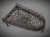 a small metal tray with a decorative design on it