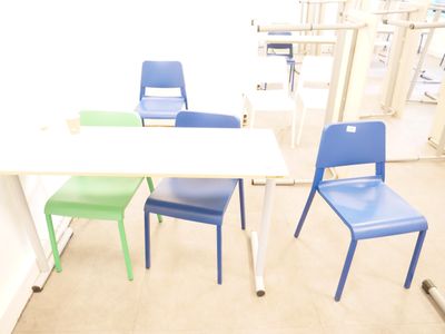three chairs and a table in a room