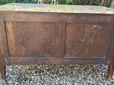 a wooden cabinet with writing on it in the gravel