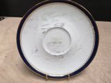 a white plate with blue trim on it on a table