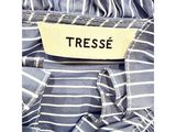 a close up of a dress label on a blue and white striped dress