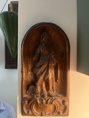 a man that is sitting in front of a statue