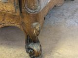 a wooden bed with a carved headboard and foot rest