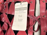 a red and black bag with a tag on it