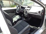 the interior of a car with the door open and the driver ' s seat down
