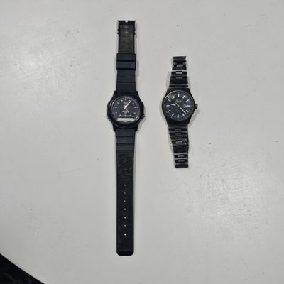 the two watches are sitting on the table next to each other