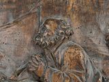 carvings of a man and a woman sitting on a bench with a dog