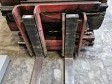 a forklift that is sitting in the middle of the floor