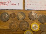 a lot of coins sitting on a table next to a piece of paper