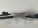 a close up of a gun on display on a white surface